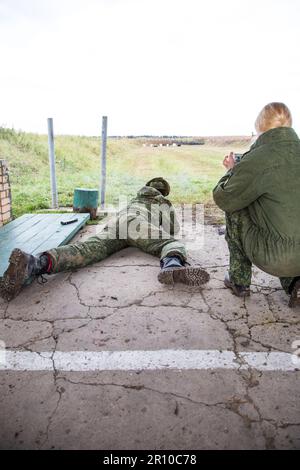 Man shooting at a target. Unformal shooting range  Stock Photo