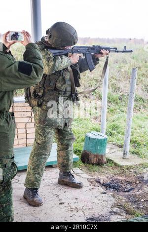 Man shooting at a target. Unformal shooting range  Stock Photo