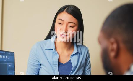 Asian industrial engineer helping 3d editor to develop cad prototype, doing teamwork with graphic software in creative agency office. Coworkers planning engineering development with skills. Stock Photo