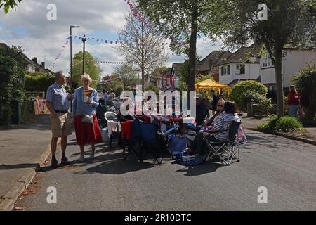 People Eating and Drinking at Street Party Celebrating King Charles III Coronation Surrey England Stock Photo