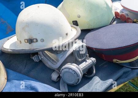 Old outdated firefighter helmet and mask Stock Photo