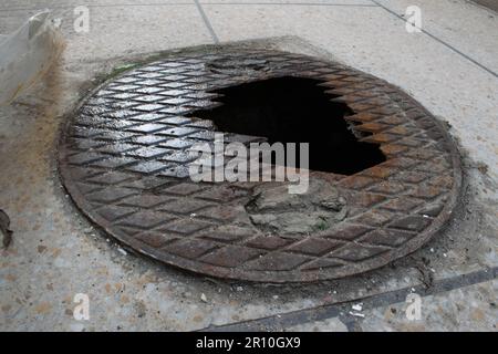 Sewer or gutter broken from the middle moldy cover. Stock Photo