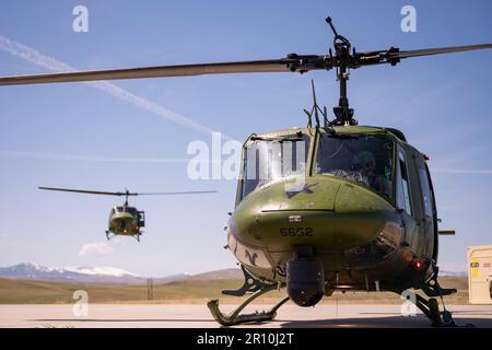 A 40th Helicopter Squadron UH-N1 Huey prepares to land beside another Huey May 2, 2023, at Malmstrom Air Force Base, Mont. The 40th Helicopter Squadron, a tenant unit assigned to Malmstrom Air Force Base, Montana, began as Detachment 5 of the 37th Air Rescue and Recovery Squadron and was one of seven detachments in the 37th ARRS under Military Airlift Command.  The 37th ARRS was activated during the Korean War when helicopters were first used for medical evacuation. After the Vietnam War, 37th ARRS was deactivated, only to be reactivated in December 1973. (U.S. Air Force photo by Airman 1st Cl Stock Photo