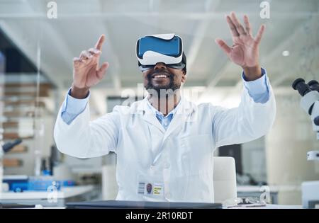 Science gives rise to new technology. a mature scientist using a virtual reality headset while working in a lab. Stock Photo