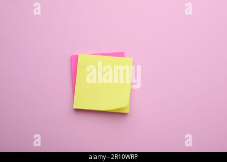 Paper notes on pale pink background, top view Stock Photo