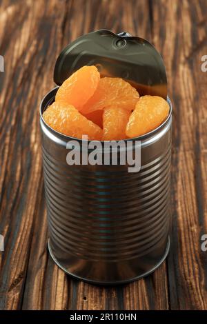 Canned Orange Tangerine in Sweet Syrup. Pickled Preserved Mandarin Fruit in the Can Stock Photo