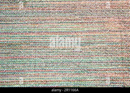 close up of woven fabric containing white, green, red, yellow and black; textile Stock Photo