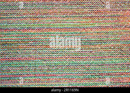 close up of woven fabric containing white, green, red, yellow and black; textile Stock Photo