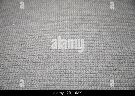 close up of gray knitted or crocheted tight knit blanket	 , This modern afghan has a new and clean look, it is very simple. This grey blanket is soft Stock Photo