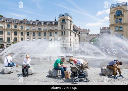 MUNICH, GERMANY, JUNE 4: Tourists at Stachus fountain in Munich, Germany on June 4, 2014. Munich is the biggest city of Bavaria with almost 100 Stock Photo