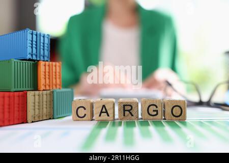 Cargo word collected with wooden cubes and shipping containers Stock Photo
