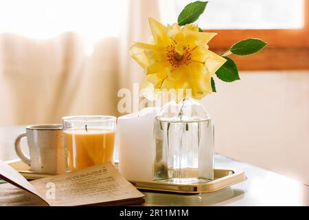 https://l450v.alamy.com/450v/2r11m1m/madrid-spain-april-25-2023-beautiful-stylish-still-life-in-spring-morning-light-a-cup-of-tea-coffee-blooming-yellow-rosebud-rose-flower-in-glass-va-2r11m1m.jpg