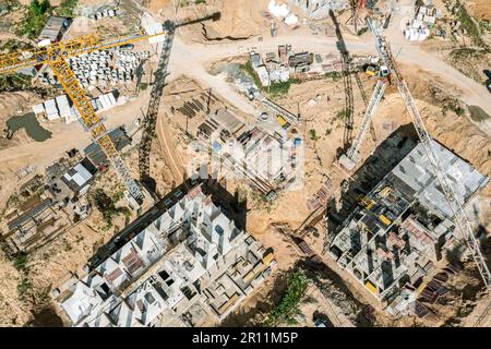 new multistory apartment builsings under construction. busy construction site with working cranes. aerial photography with drone. Stock Photo