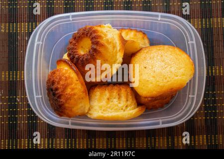 muffins in a plastic box on a table in the kitchen Stock Photo