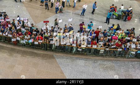 taxi drivers with signposts waiting for customers at Ngurah Rai, Denpasar International Airport, Bali, Indonesia, April 26, 2018 Stock Photo