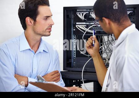 Server room, it support and cable with an engineer chatting to a business man about network management. Maintenance, database and clipboard with a Stock Photo