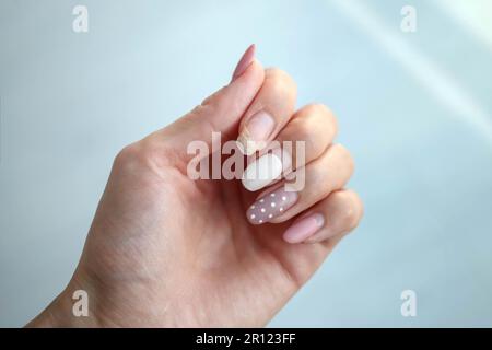 Weak thin nail. Consequences of gel polish manicure. Regrown nails after shellac. Stock Photo