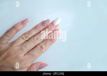 Weak thin nail. Consequences of gel polish manicure. Regrown nails after shellac. Stock Photo