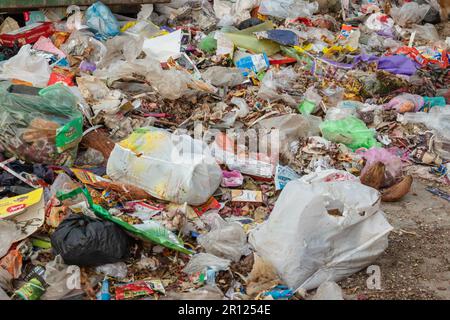 garbage waste items and plastic begs liter in open at day from different angle Stock Photo