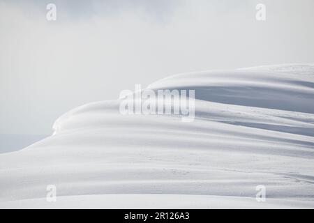Shadows and light on mountain snowdrift cornice, Hokkaido, Japan Stock Photo