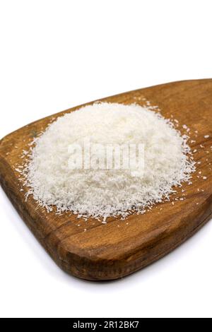 Grounded coconut flakes isolated on white background. Coconut shavings on a wood presentation board Stock Photo