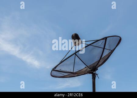 Old satellite dish on blue sky baclground Stock Photo