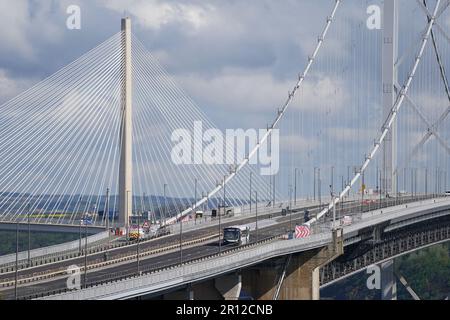 One of the new buses crosses Forth Road Bridge in Scotland, during the launch of the UK's first autonomous bus service. A fleet of five Alexander Dennis Enviro200AV vehicles will cover a 14-mile route, in mixed traffic, at up to 50mph across the Forth Road Bridge near Edinburgh. Picture date: Thursday May 11, 2023. Stock Photo