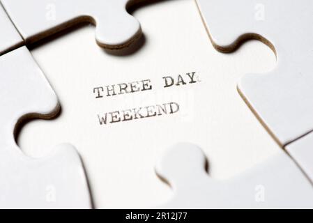Three day weekend text written with a typewriter in a white puzzle Stock Photo