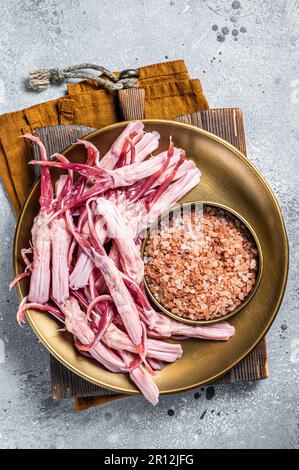 Fresh Raw Duck Tongue ready for cooking. Gray background. Top view. Stock Photo