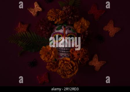 Dia De Los Muertos or Day of the Dead Celebration Banner with Empty Space. Low key photo of Scull Decorated with Marigold flower. Mexican Festive. Stock Photo