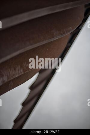 The Antony Gormley sculpture 'The Angel of the North' in Gateshead, England, UK stands high on top of a hillside underneath a dramatic cloudy sky Stock Photo