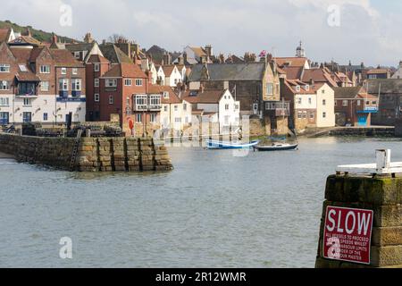 Boats in the harbour of the pretty coastal town of Whitby, UK, popular with tourists. Stock Photo