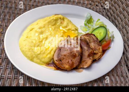 Mashed potato with chicken meat roulade with cheese and cranberries on white plate, closeup. Stock Photo