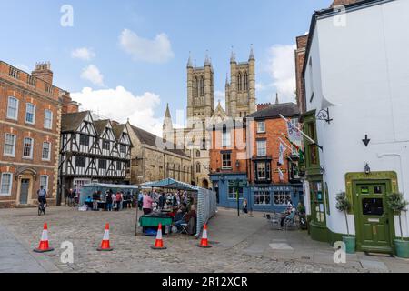 A view of the city of Lincoln, UK marketplace with the iconic Cathedral seen in the background. Stock Photo