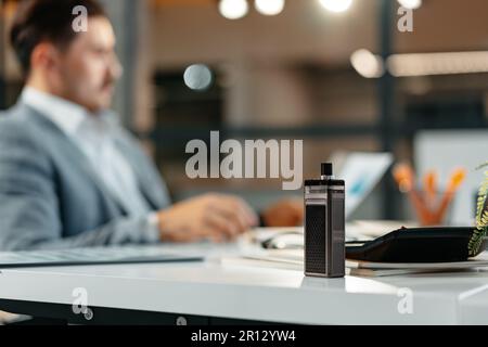 Vape on the working table of a male businessman Stock Photo