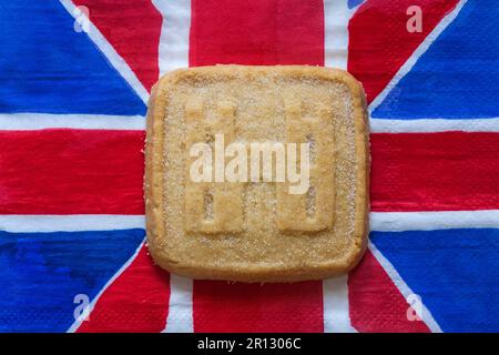 all butter shortbread biscuit to commemorate The Coronation of HM King Charles III 2023 from M&S on Union Jack napkin serviette Stock Photo