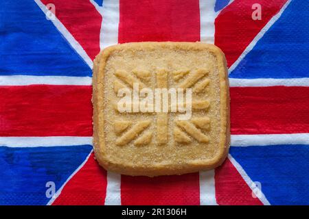 all butter shortbread biscuit to commemorate The Coronation of HM King Charles III 2023 from M&S on Union Jack napkin serviette Stock Photo