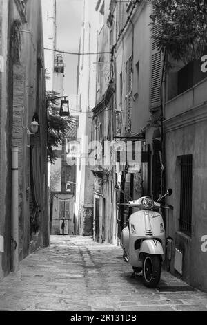 black and white old city in corsica during my travel. it was a sunny day and really hot. I was lucky to find no one on this street Stock Photo