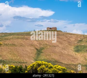 Tuscany landscape in the spring season with the farmhouse - Tuscany region in the central Italy. Farmhouse at Tuscany hill - Europe Stock Photo
