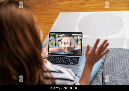 A man calls his girlfriend on video from the pool at the resort Stock Photo