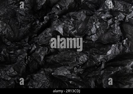 Black crumpled paper texture. wavy textured background. Stock Photo