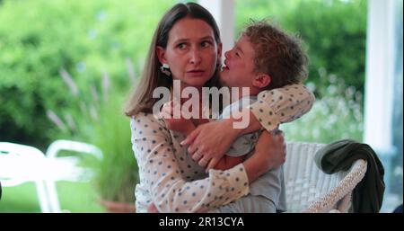 Mother consoling child boy. Candid authentic parent soothing and calming crying toddler son Stock Photo