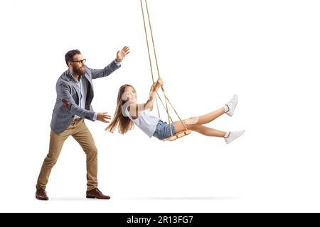 Full length shot of a father pushing a girl on a swing isolated on white background Stock Photo