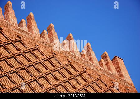 Architectural details of Michelet Center Art and Archeology library in Paris, France. Red brick wall and blue sky. Abstract background. Stock Photo