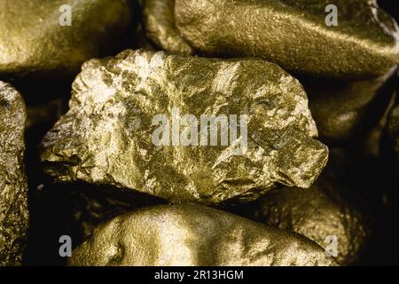 gold texture, many gold nugget, stone of value. Crude gold drawn on black background. Concept of wealth or luxury. Stock Photo