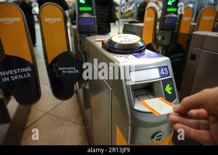 London, England, UK. Ticket barrier on the London Underground - passenger (photographer) putting a ticket through the machine Stock Photo