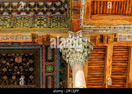 detail of the intricately carved colourful wooden roof of the iwan of the bolo hauz mosque in bukhara uzbekistan Stock Photo