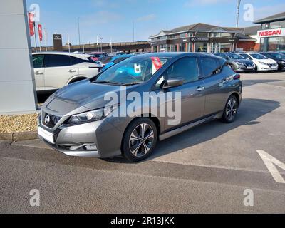 A used Nissan Leaf Electric Vehicle on a Nissan dealership forecourt in Weston-super-Mare, North Somerset, England. Stock Photo