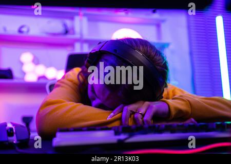 After a lengthy period of practice, professional gamer always get neck, shoulder, back, finger pain. Tired, exhausted ,sleepy are results of repetitiv Stock Photo
