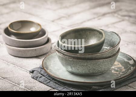 Gray stoneware plates and bowls on a rustic table, copy space Stock Photo